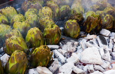 Fototapeta na wymiar Artichokes being grilled on charcoal