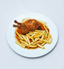 Quail in sauce with chips, typical tapa in a bar of Triana, Seville, Spain