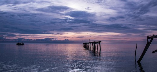 Purple sunset over amaged pier