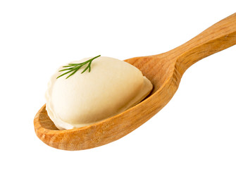 Dumpling with dill leaf in wooden spoon close - up on a white. Isolated.