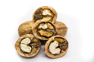 a few walnut in shell and peeled on white background