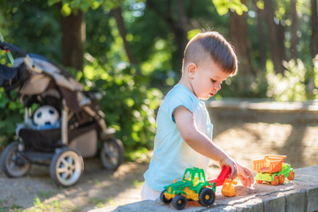 little baby playing with toys in the park on a sunny day