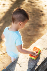 little baby playing with toys in the park on a sunny day
