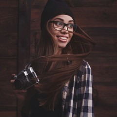 girl in glasses and braces with vintage camera