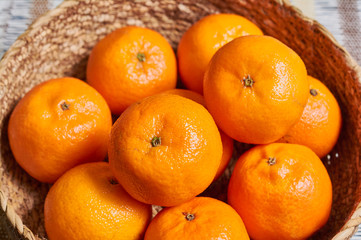 tangerine basket with artisan tablecloth background