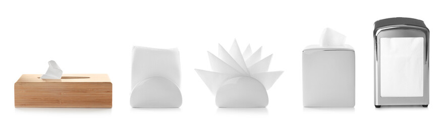 Set of different modern napkin holders with paper serviettes on white background