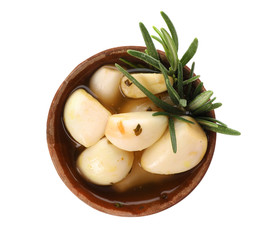 Bowl with preserved garlic and rosemary on white background, top view