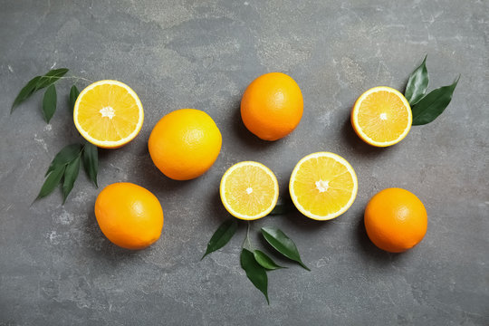 Flat lay composition with fresh oranges on grey background © New Africa