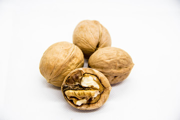 a few walnut in shell and peeled on white background