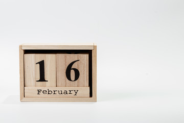Wooden calendar February 16 on a white background