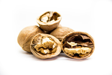 a few walnut in shell and peeled on white background