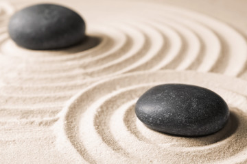 Fototapeta na wymiar Zen garden stones on sand with pattern. Meditation and harmony
