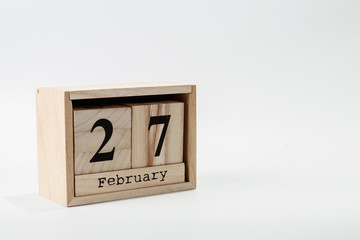 Wooden calendar February 27 on a white background