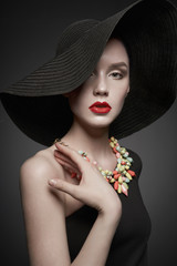 portrait of young lady with black hat and evening dress