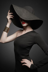 Fototapeta na wymiar portrait of young lady with black hat and evening dress