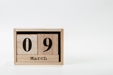 Wooden calendar March 09 on a white background