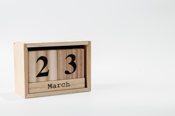 Wooden calendar March 23 on a white background