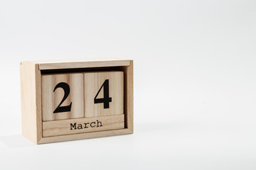 Wooden calendar March 24 on a white background