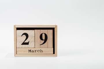 Wooden calendar March 29 on a white background