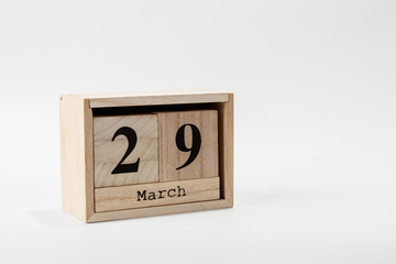Wooden calendar March 29 on a white background