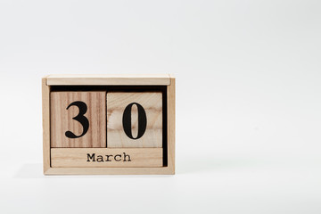 Wooden calendar March 30 on a white background