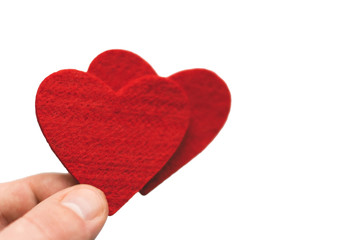 Red Heart in the fingers on a white background. Valentine's Day