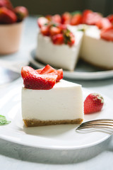 Classic cheesecake with strawberries on a white plate. Berry Cake Slice