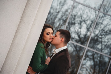 Close up of happy romantic attractive young couple kissing and hugging at the street