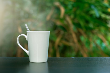 Obraz na płótnie Canvas Coffee in a white cup on the table