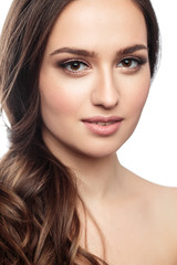 Obraz premium Brunette girl with healthy curly hair and natural make up . Beautiful model woman with wavy hairstyle .Care and beauty