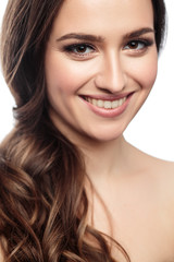 Fototapeta premium Brunette girl with healthy curly hair and natural make up . Beautiful model woman with wavy hairstyle .Care and beauty