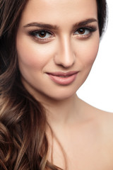 Obraz premium Brunette girl with healthy curly hair and natural make up . Beautiful model woman with wavy hairstyle .Care and beauty