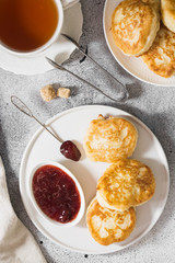 Pancakes on a white plate on a gray background. Breakfast
