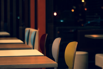 Colorful chairs and tables in a restaurant.