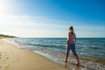 Woman waking on beach