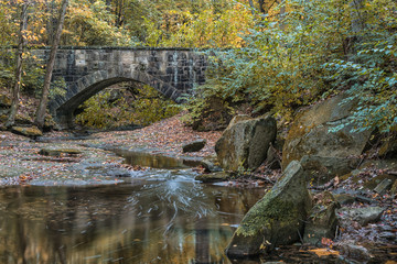 Stone Bridge over Stream with Silky Water Autumn
