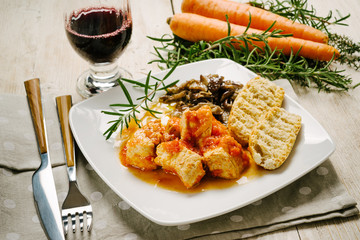 Meat stew with mushrooms on the white plate