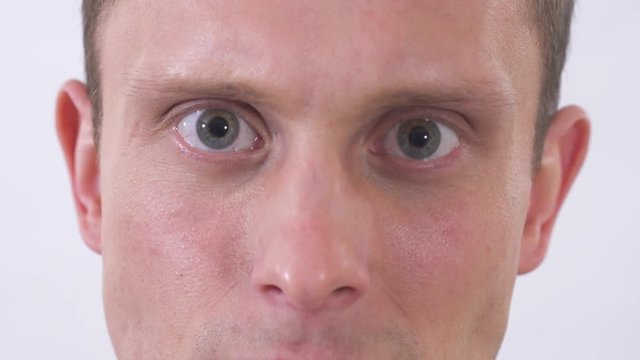 Mans eyes showing hate and angry amotions. Shooting on a white background.