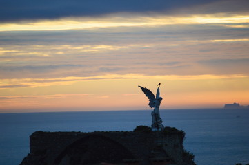 A dark cloudy sunrise by the Cantabrian sea at Comillas cemetery, Cantabria, Spain	