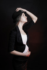stylish young woman in black hat posing for the camera