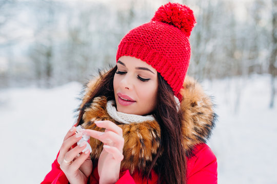 Girl protecting lips with lip balm in winter