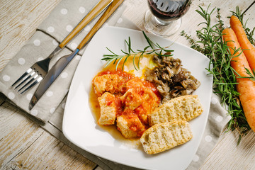 Meat stew with mushrooms on the white plate
