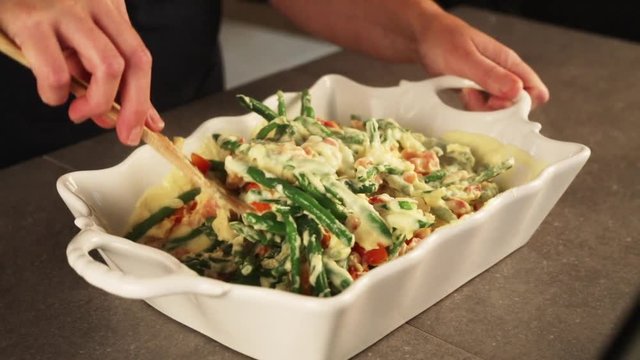 Person mixes green bean casserole