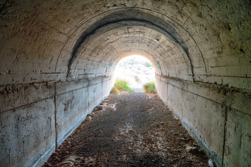 Abandoned tunnel with light at end