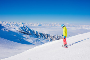 Girl snowboarder having fun in the winter ski resort.