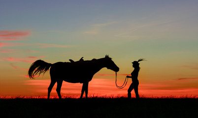 Silhouette of woman in hat feather walks with horse at bright sunset, multicolored  clouds. Lady in old English steampunk style riding a horse at tranquil landscape.