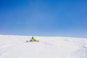 Girl snowboarder having fun in the winter ski resort.