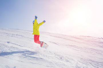 Girl snowboarder having fun in the winter ski resort.