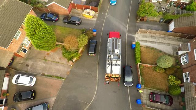Aerial View, footage of Dustmen putting recycling waste into a garbage truck, Bin men, refuse collectors. bin lorry, Recycling day, Video No1 of 8