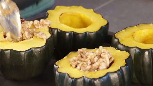 Spooning filling into acorn squash